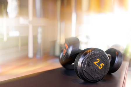 Dumbbell in fitness room at the morning with beautiful sun lightの写真素材
