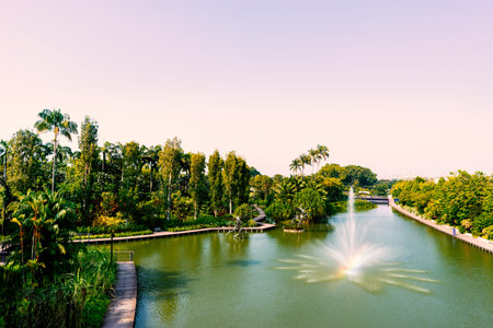 Scenic view of fountain and beautiful lake in the park under clear skyの写真素材
