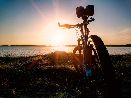 Mountain bike parking at lake after biking in the morningの写真素材