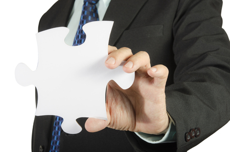 Business man showing  jigsaw puzzle piece. Concept for business strength and success.の写真素材