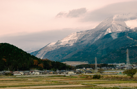 Autumn at Japanese countryside landscape with rice field and mountainの写真素材