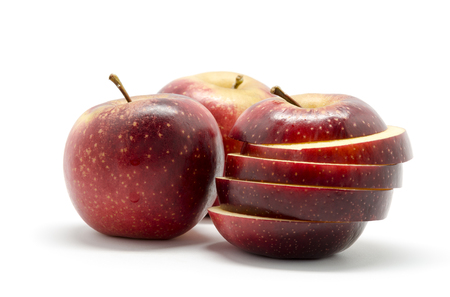 Red and sliced apples , isolated on white backgroundの写真素材