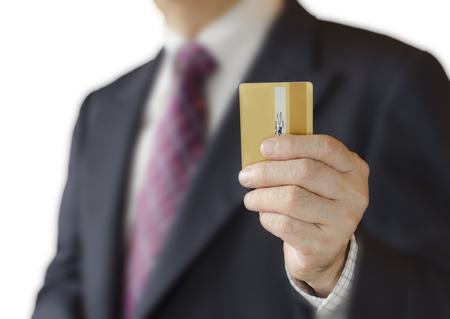 Blank credit card in a hand , Isolated on white backgroundの写真素材