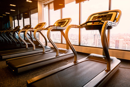 Row of empty treadmill in fitness room at the morning wait for exercise