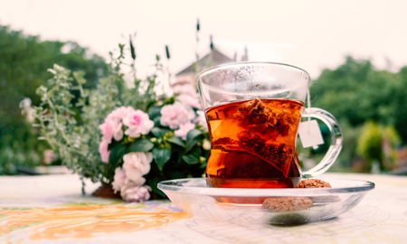English style afternoon hot herbal tea with cookies at the backyard gardenの写真素材