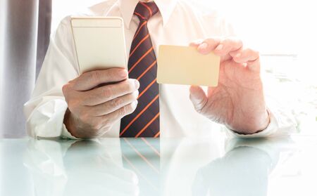 Businessman using smartphone and credit card for online e-commerceの写真素材