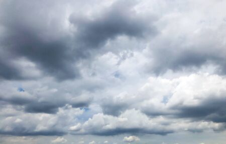 Clouds are forming above the blue sky before turning into  stormの写真素材