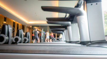 Blurred people exercising in fitness roomの写真素材