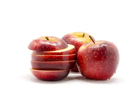 Red and sliced apples , isolated on white backgroundの写真素材
