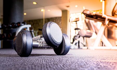 Dumbbell on the floor in luxury fitness club at the morning , Concept for healthy lifestyleの写真素材