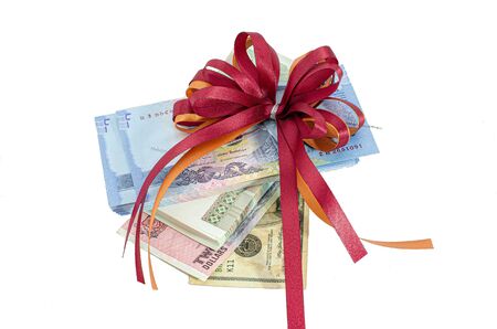 Gifts that are banknotes wrapped in a bow on white background : Concept for award and celebrationの写真素材