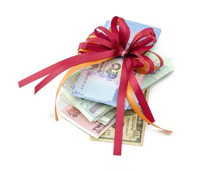 Gifts that are banknotes wrapped in a bow on white background : Concept for award and celebrationの写真素材