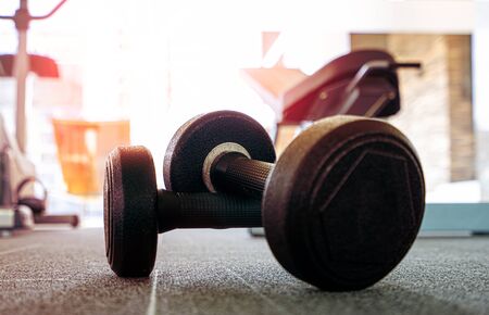 Dumbbell on the floor in luxury fitness club at the morning , Concept for healthy lifestyleの写真素材