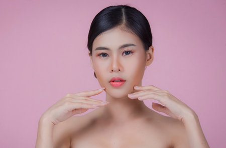 Beauty Spa Woman with perfect skin Portrait. Asian beautiful woman skin makeup young model, on pink studioの写真素材