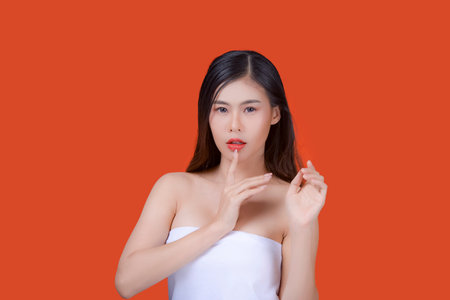 Asian beautiful woman portrait beauty hair and skin makeup young model, on Orange studio