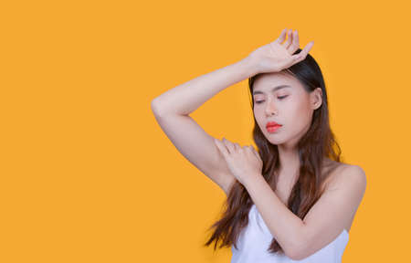 Beauty and healthcare. Portrait of young and beautiful asian woman on yellow backgroundの写真素材