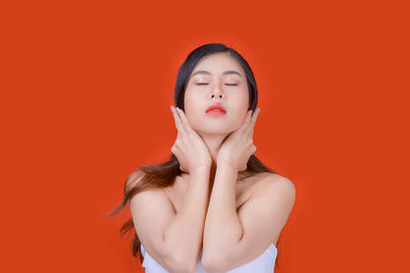 Asian beautiful woman portrait beauty hair and skin makeup young model, on Orange studioの写真素材