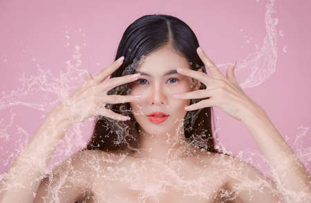 Beauty Spa Woman with perfect skin Portrait. Asian beautiful woman skin makeup young model, on pink studioの写真素材