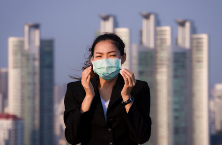 Portrait of an Asian woman wearing a black oil mask, anti-virus. Feeling stressedの写真素材