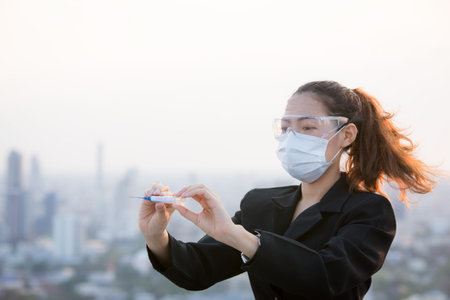 Portrait of an Asian woman wearing a black oil mask, anti-virus. Feeling stressed