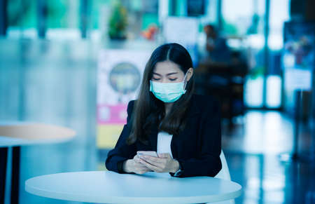 Portrait of an Asian woman wearing a black oil mask, anti-virus, or anti-Covid-19. Feeling stressedの写真素材