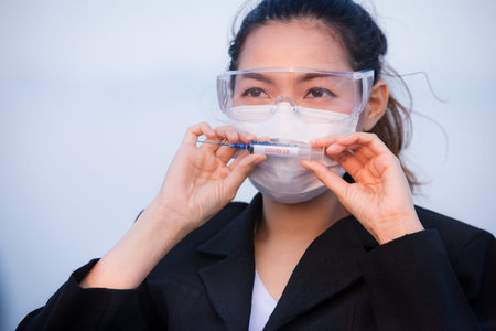 Portrait of an Asian woman wearing a black oil mask, anti-virus, or anti-Covid-19. Feeling stressedの写真素材