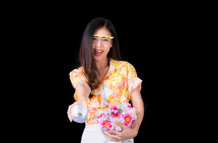 Thai girl smiling Asian beauty Swimming with ancient bowls Preserve the good culture of Thai people during Songkran festival. Thai New Year, Family Day in Aprilの写真素材