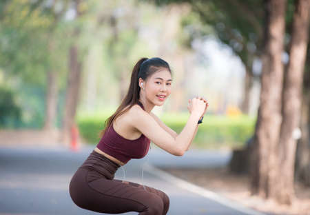 Asian woman is warming up, To make the muscles flexible Before going to jogging for good health and energy metabolism, Outdoors cross training workout. Healthcare conceptの写真素材