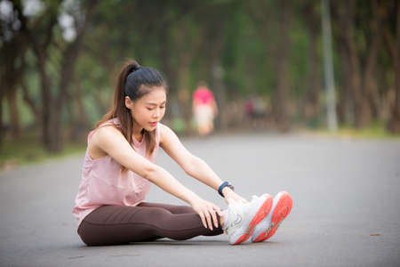 Asian woman is warming up, To make the muscles flexible Before going to jogging for good health and energy metabolism, Outdoors cross training workout. Healthcare conceptの写真素材
