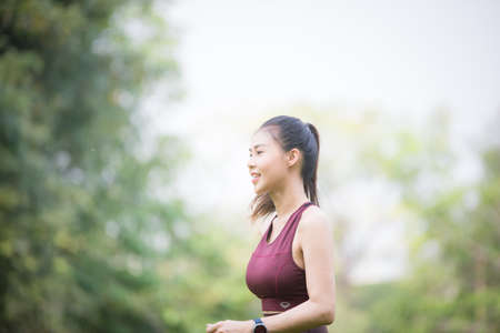 Asian woman is warming up, To make the muscles flexible Before going to jogging for good health and energy metabolism, Outdoors cross training workout. Healthcare conceptの写真素材