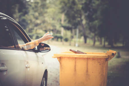 Woman hand picking up garbage plastic for cleaning at parkの写真素材