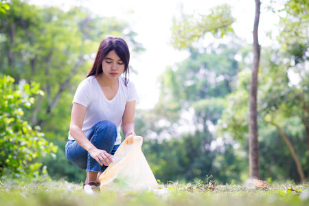Asian Young women putting empty plastic bottle in recycling bin.Environmental conservation.