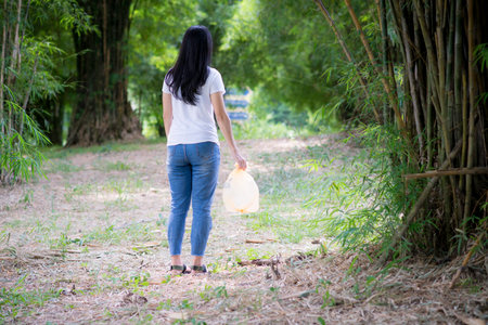 Asian Young women putting empty plastic bottle in recycling bin.Environmental conservation.の写真素材