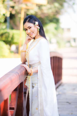 Asian Young women, Portrait of a beautiful thai woman wearing a thai dress,Smile with happiness.の写真素材