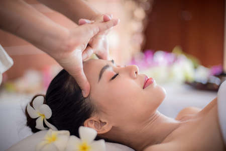 Body care. Spa body massage Asian woman hands treatment. Woman having massage in the spa salonの写真素材