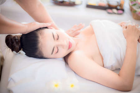Body care. Spa body massage Asian woman hands treatment. Woman having massage in the spa salonの写真素材
