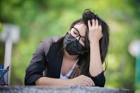 Asian women wearing masks and are under stress due to a global epidemic.の写真素材