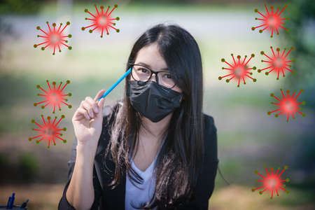 Asian women wearing masks and are under stress due to a global epidemic.Corona virus, or Covid-19 virusの写真素材