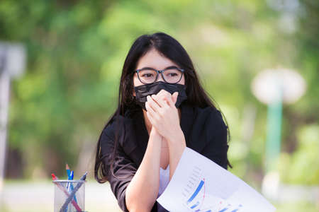 Asian women wearing masks and are under stress due to a global epidemic.の写真素材