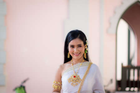 Asian Young women, Portrait of a beautiful thai woman wearing a thai dress,Smile with happiness.の写真素材