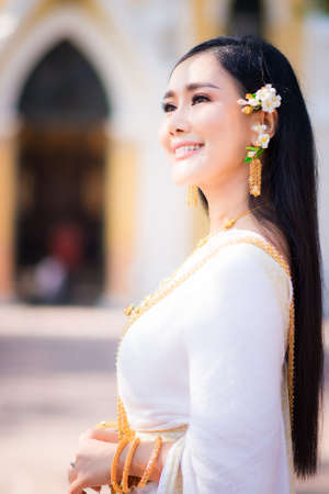 Asian Young women, Portrait of a beautiful thai woman wearing a thai dress,Smile with happiness.の写真素材