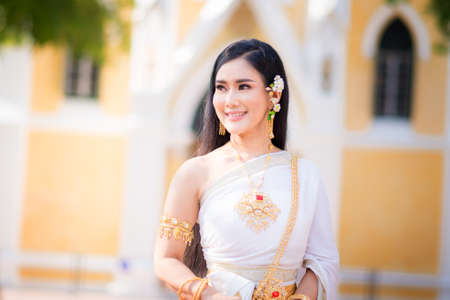 Asian Young women, Portrait of a beautiful thai woman wearing a thai dress,Smile with happiness.の写真素材
