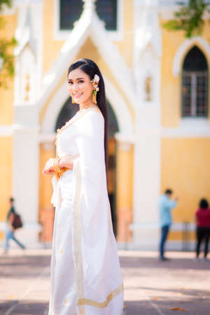 Asian Young women, Portrait of a beautiful thai woman wearing a thai dress,Smile with happiness.の写真素材