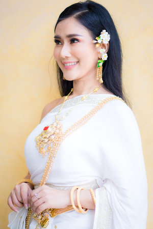 Asian Young women, Portrait of a beautiful thai woman wearing a thai dress,Smile with happiness.の写真素材