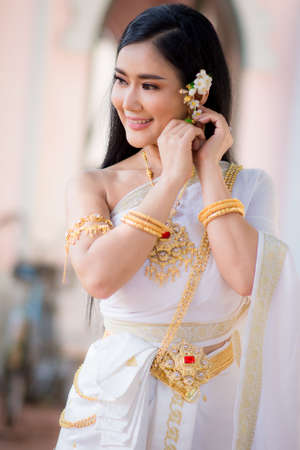 Asian Young women, Portrait of a beautiful thai woman wearing a thai dress,Smile with happiness.の写真素材