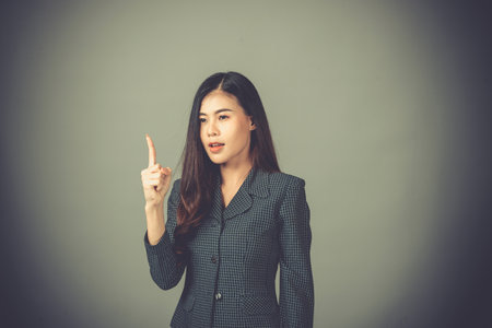 Portrait of an Asian woman, working days are very stressful.businesswoman , on Gray background in the studio,Vintage style picturesの写真素材