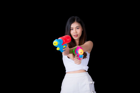 Young happy beauty Asian woman holding plastic water gun at Songkran festival, Thailand. Thai New...