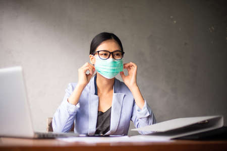 Asian business women wear masks working from home And introvert after virus outbreakの写真素材