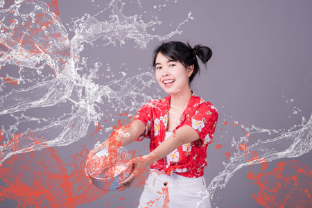 Portrait cheerful young asian woman holding plastic water gun Smiling and having fun playing in the...