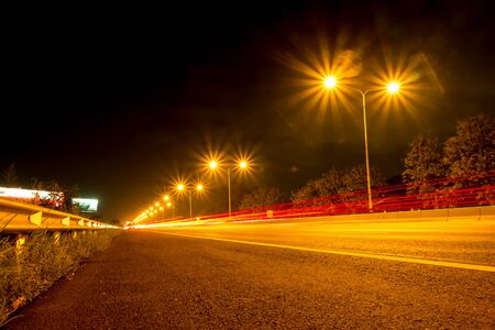 The car lights line the roads at night .の写真素材